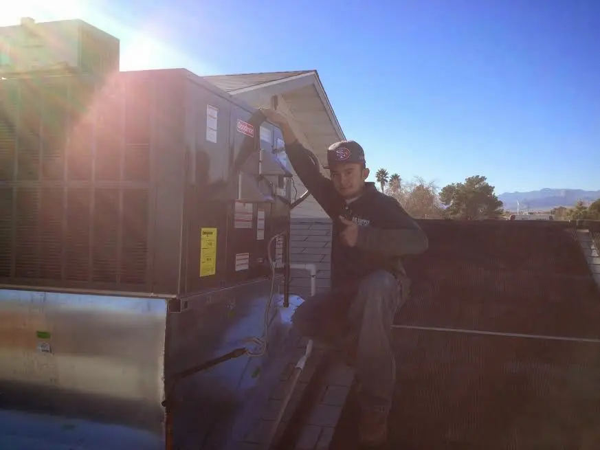 HVAC technician performing Heat Pump Repair on a rooftop unit in Fairview Shores